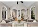 Cozy sitting area featuring arched windows, hardwood floors, and comfortable seating at 1078 Shady Valley Ne Pl, Atlanta, GA 30324