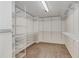 Walk-in closet with white wire shelving and neutral carpet flooring at 1078 Shady Valley Ne Pl, Atlanta, GA 30324