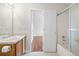 Bathroom features a white vanity and a shower and tub combination at 1486 Rogers Crossing Dr, Lithonia, GA 30058