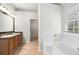 Bathroom boasting double sinks, tub, and a walk-in closet at 1486 Rogers Crossing Dr, Lithonia, GA 30058