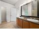 Bathroom features double sinks and wood-look floors at 1486 Rogers Crossing Dr, Lithonia, GA 30058