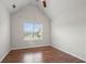 Bright bedroom featuring hardwood floors, neutral walls, and a large window providing natural light at 1486 Rogers Crossing Dr, Lithonia, GA 30058
