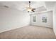Bedroom showcasing neutral carpet, white walls, a modern ceiling fan, and great natural light at 1486 Rogers Crossing Dr, Lithonia, GA 30058