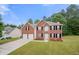 Charming two-story brick home with a well-maintained lawn and a two-car garage at 1486 Rogers Crossing Dr, Lithonia, GA 30058
