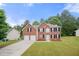 Charming two-story brick home with a well-maintained lawn and a two-car garage at 1486 Rogers Crossing Dr, Lithonia, GA 30058