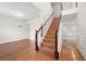 Inviting foyer with gleaming hardwood floors and a staircase leading to the upper level at 1486 Rogers Crossing Dr, Lithonia, GA 30058