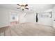 Spacious open-concept living room with hardwood floors and a carpeted area, with an open plan at 1486 Rogers Crossing Dr, Lithonia, GA 30058