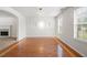 Open concept living room with hardwood floors, connecting to an adjacent carpeted area at 1486 Rogers Crossing Dr, Lithonia, GA 30058