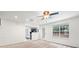 Open-concept living room with plush carpet and a ceiling fan at 1486 Rogers Crossing Dr, Lithonia, GA 30058