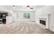 Spacious living room features a fireplace, plush carpeting, and a walk-out to the backyard at 1486 Rogers Crossing Dr, Lithonia, GA 30058
