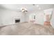 Comfortable living room with a fireplace, plush carpeting, and an open floor plan at 1486 Rogers Crossing Dr, Lithonia, GA 30058