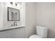 Small powder room offers granite counters, modern vanity and fixtures at 1486 Rogers Crossing Dr, Lithonia, GA 30058