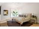 Cozy bedroom with a neutral palette, natural light, plush bedding, and a textured rug at 77 Delmont Ne Dr, Atlanta, GA 30305