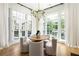Dining room with a modern light fixture and large windows offering plenty of light at 77 Delmont Ne Dr, Atlanta, GA 30305