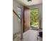 Inviting entryway with a wooden door, staircase, and light hardwood floors with natural light at 77 Delmont Ne Dr, Atlanta, GA 30305