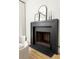 Modern black fireplace with white walls and a small chair at 77 Delmont Ne Dr, Atlanta, GA 30305