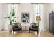 Comfortable sitting area featuring stylish chairs, modern art, and ample natural light from large windows at 77 Delmont Ne Dr, Atlanta, GA 30305