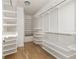Spacious walk-in closet with custom white shelving and hardwood floors at 77 Delmont Ne Dr, Atlanta, GA 30305