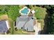 Aerial view of a home, highlighting the sparkling backyard pool, mature trees, and well-maintained lawn at 1501 Laurelhill Drive Southwest Dr, Lawrenceville, GA 30044