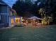 Evening view of backyard featuring covered porch, outdoor dining and pool at 1501 Laurelhill Drive Southwest Dr, Lawrenceville, GA 30044