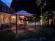 Backyard featuring an outdoor dining area and pool illuminated with decorative lighting at 1501 Laurelhill Drive Southwest Dr, Lawrenceville, GA 30044