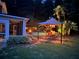 Twilight view of backyard featuring patio dining, outdoor kitchen and pool at 1501 Laurelhill Drive Southwest Dr, Lawrenceville, GA 30044