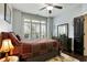 Sunlit bedroom with hardwood floors, plantation shutters, and a dark wood dresser at 1501 Laurelhill Drive Southwest Dr, Lawrenceville, GA 30044