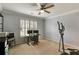 Bright bedroom with a ceiling fan, neutral carpet, and plantation shutters for a cozy feel at 1501 Laurelhill Drive Southwest Dr, Lawrenceville, GA 30044
