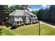 Beautifully landscaped lawn and garden highlighting the exterior and roof of this two-story home at 1501 Laurelhill Drive Southwest Dr, Lawrenceville, GA 30044