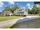 Well-manicured lawn and garden highlighting the exterior and roof of this two-story home and driveway at 1501 Laurelhill Drive Southwest Dr, Lawrenceville, GA 30044