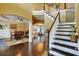Elegant foyer with gleaming hardwood floors, a staircase with white railings, and views into the dining room at 1501 Laurelhill Drive Southwest Dr, Lawrenceville, GA 30044