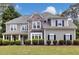 Charming two-story home with stone accents, a welcoming front porch, manicured lawn, and lush landscaping at 1501 Laurelhill Drive Southwest Dr, Lawrenceville, GA 30044