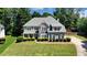 Well-manicured lawn highlighting the exterior of this two-story home with stone accents and a long driveway at 1501 Laurelhill Drive Southwest Dr, Lawrenceville, GA 30044