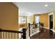 Upstairs hallway featuring a decorative chandelier and view of the home's main level at 1501 Laurelhill Drive Southwest Dr, Lawrenceville, GA 30044