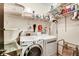 Functional laundry room with washer, dryer, storage shelves, and hanging racks at 1501 Laurelhill Drive Southwest Dr, Lawrenceville, GA 30044