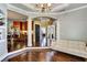 Open-concept living area with hardwood floors, white columns, and views into kitchen at 1501 Laurelhill Drive Southwest Dr, Lawrenceville, GA 30044