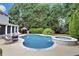 Backyard features a sparkling pool with spa and lounging area surrounded by lush landscaping at 1501 Laurelhill Drive Southwest Dr, Lawrenceville, GA 30044