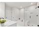 Modern bathroom with separate tub and glass-enclosed shower, white tile, and sleek fixtures at 2445 Hidden Creek Rd, Kennesaw, GA 30152