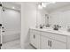 Bright bathroom with double sink vanity and combined shower and tub at 2445 Hidden Creek Rd, Kennesaw, GA 30152
