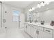 This spacious bathroom includes a double vanity, modern fixtures, and a separate glass shower for a luxurious feel at 2445 Hidden Creek Rd, Kennesaw, GA 30152