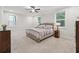 Comfortable bedroom with plush carpeting, a ceiling fan, and ample natural light creating a relaxing atmosphere at 2445 Hidden Creek Rd, Kennesaw, GA 30152