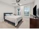 Serene bedroom with a comfortable bed, natural light from two windows, and a ceiling fan for added comfort at 2445 Hidden Creek Rd, Kennesaw, GA 30152