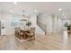 Open-concept dining area with hardwood floors, a modern chandelier, and ample natural light at 2445 Hidden Creek Rd, Kennesaw, GA 30152