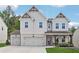 Charming two-story home with brick accents, a three-car garage, and a well-manicured lawn at 2445 Hidden Creek Rd, Kennesaw, GA 30152