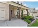 Inviting front porch with brick supports, stylish seating, and decorative landscaping at 2445 Hidden Creek Rd, Kennesaw, GA 30152