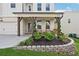 Charming front porch featuring stone accents, seating, and beautiful landscaping for a welcoming entrance at 2445 Hidden Creek Rd, Kennesaw, GA 30152