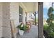 Cozy front porch with brick columns, comfortable seating, and a decorative flower pot at 2445 Hidden Creek Rd, Kennesaw, GA 30152