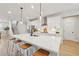 Bright kitchen with stainless steel appliances, a large island with seating, and modern pendant lighting above the island at 2445 Hidden Creek Rd, Kennesaw, GA 30152