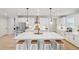 Modern kitchen with stainless steel appliances, a large island with a marble countertop, and stylish pendant lighting at 2445 Hidden Creek Rd, Kennesaw, GA 30152