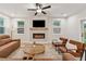 Cozy living room with a fireplace, comfortable seating, and plenty of natural light at 2445 Hidden Creek Rd, Kennesaw, GA 30152